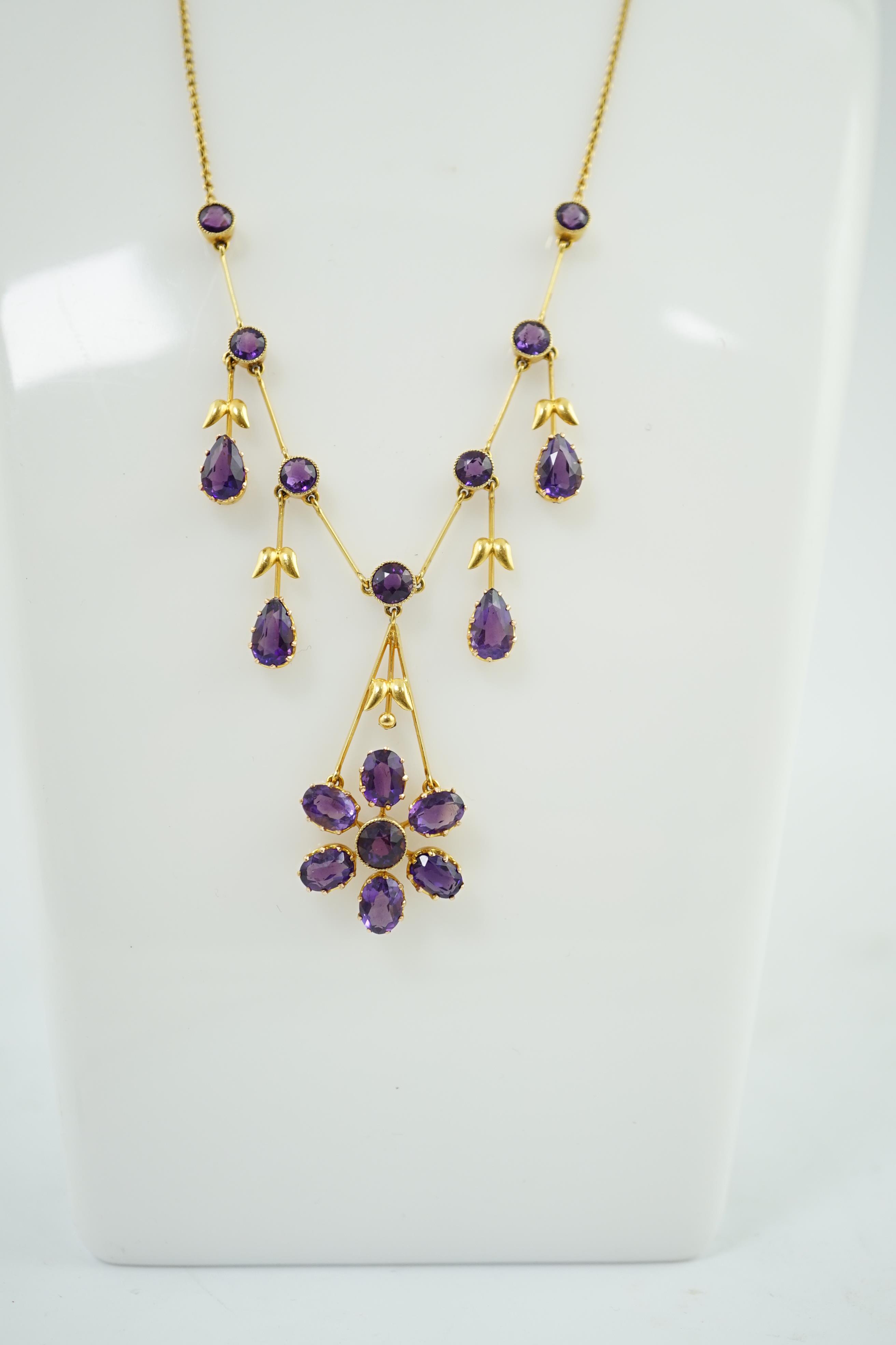 An Edwardian gold, and amethyst cluster drop pendant necklace